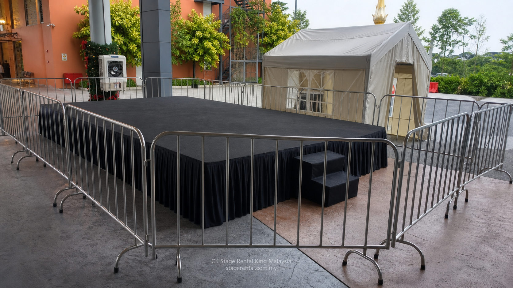 Black skirted outdoor stage with tent barricade by CK Stage Rental King Malaysia